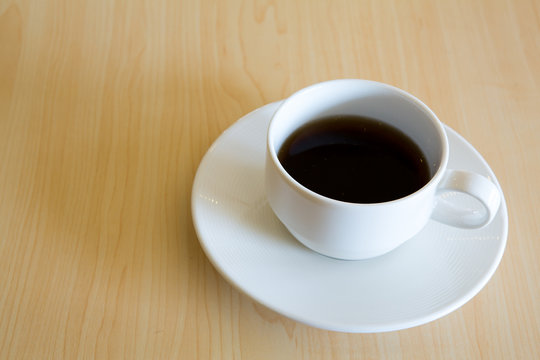Coffee cup on the wooden table
