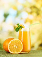 Glass of orange juice with mint and orange