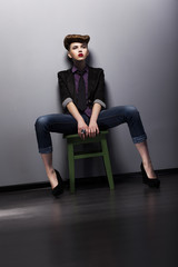 Atrractive Fashionable Brunette sitting. Elegance
