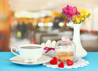 Cupcake on saucer with glass cover, on bright background