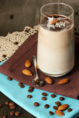 Glass of chocolate-cream cocktail on wooden table close-up