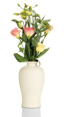 Bouquet of eustoma flowers in vase isolated on white