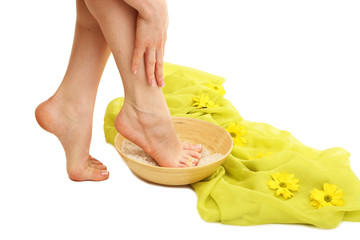 Obraz na płótnie Canvas Female feet in spa bowl with sea salt, isolated on white