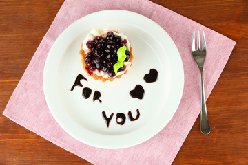 Sweet cake with blackberry and chocolate sauce