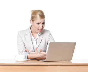 Attractive business woman sitting at a desk with laptop