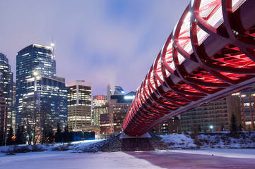Calgary skyline and pedestrian bridge at night.