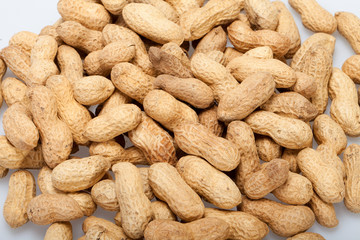 .Dried peanuts in closeup on the white background