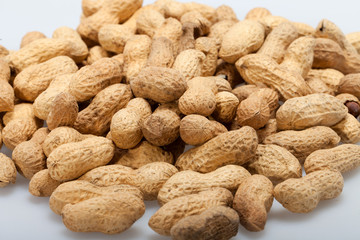 .Dried peanuts in closeup on the white background