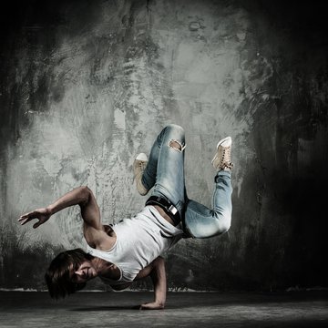 Young b-boy man doing brake dancing movements