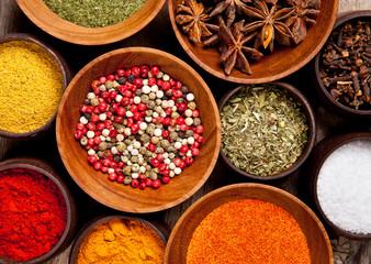 Various kind of spices in wooden bowls