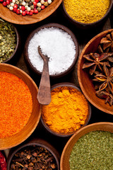 Various kind of spices in wooden bowls