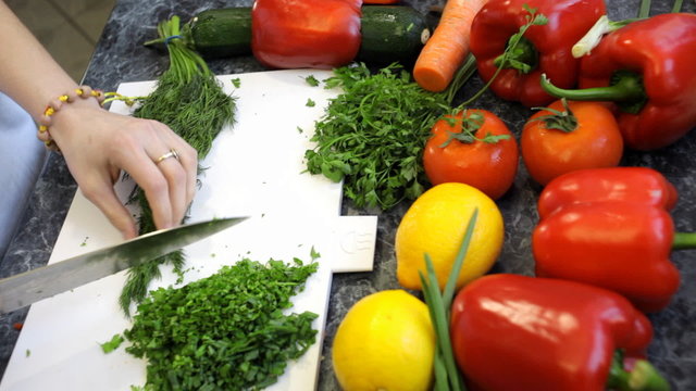 slicing dill with a knife chef