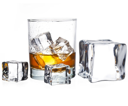 glass of whisky with ice cubes isolated on white 