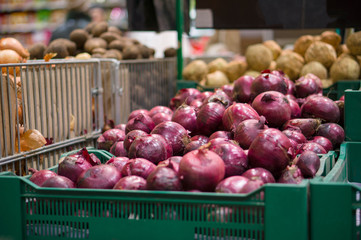 Bunch of red onion on boxes in supermarket