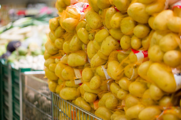 Bunch of potatoes in fence bags in supermarket
