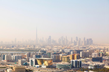 Fototapeta na wymiar Dubai's skyscrapers and top view on a sunny day