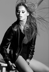 sexy young model wearing a leather jacket posing fashion © matusciac