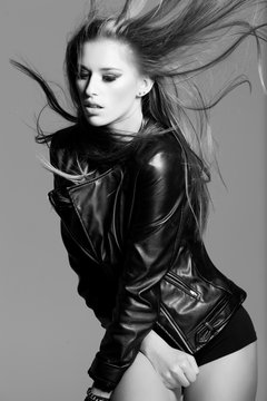 sexy young model wearing a leather jacket posing fashion