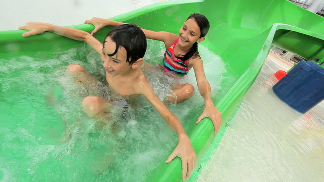 Caucasian Children Laughing on Water Chutes