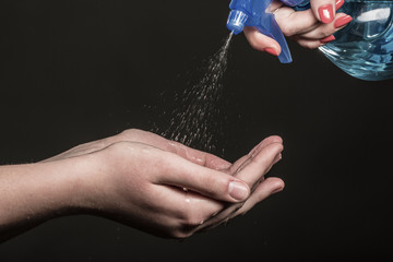 Fototapeta na wymiar The spray pours water on a hand