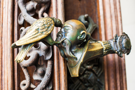 Decorative antique, metal door handles with bird pattern.