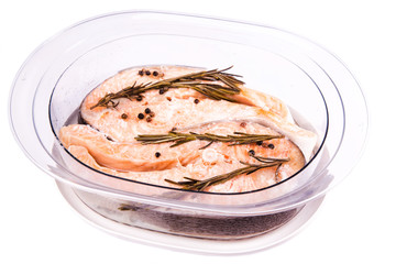 Cooked salmon steak with rosemary in a steamer