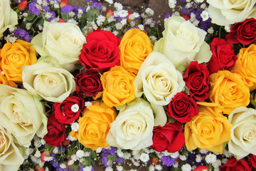 Obraz na płótnie Canvas Yellow, white and red roses in a wedding arrangement