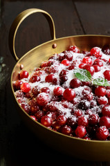 Wild cranberries with sugar in metal bowl