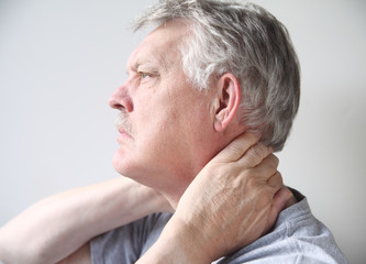man with pain in neck