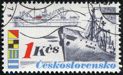 stamp shows an old style freighter with cranes on deck