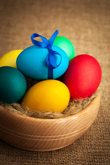 wooden bowl with colored Easter eggs