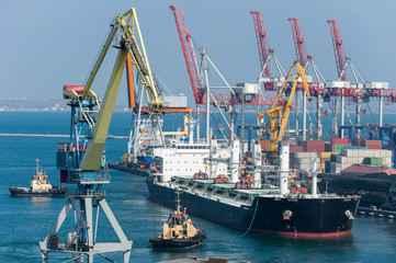 cargo ship and tug boat in port