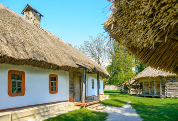 A typical antique Ukrainian country house with a thatch roof, in the countryside near Kiev	