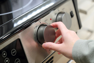 Woman turning on the oven