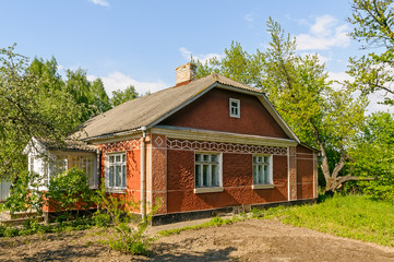 Fototapeta na wymiar A typical red Ukrainian house, in the countryside near Kiev 