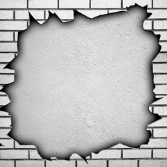 cracked brick wall with large hole
