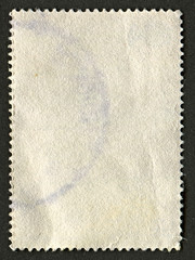 The reverse side of a postage stamp.