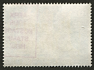 The reverse side of a postage stamp.