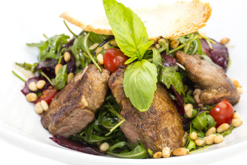 rabbit liver salad with arugula in a restaurant