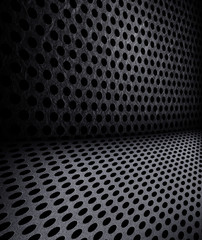 Background sheet of metal covered with lines of circular holes.