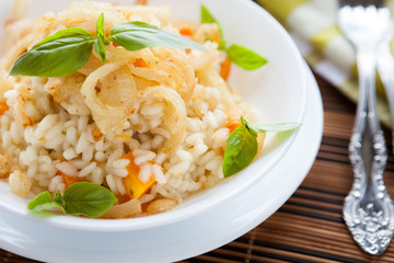 Arborio rice with onions in a white bowl