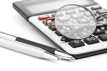 glasses and pen on calculator