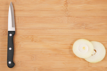 Fototapeta na wymiar Knife and onion on cutting board