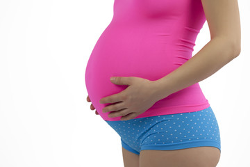 Pregnant woman holding belly in pink and blue.