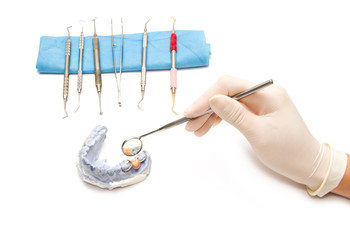 Dental prosthesis on gypsum model plaster with dental tool