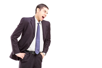 Angry young man in a suit shouting