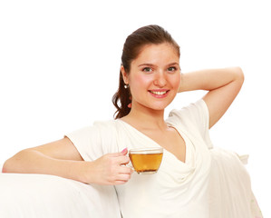 Relaxed young woman with cup of tea sitting