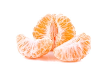 Pieces of orange tangerine isolated over white background
