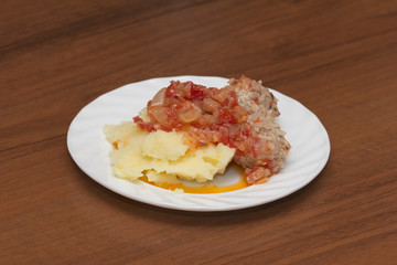 cutlet with potatoes in tomato sauce
