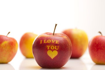 apple with the words  I LOVE YOU arranged in a row